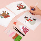 Working on several Christmas Pets & Cheer mini diamond painting designs with drills and applicator