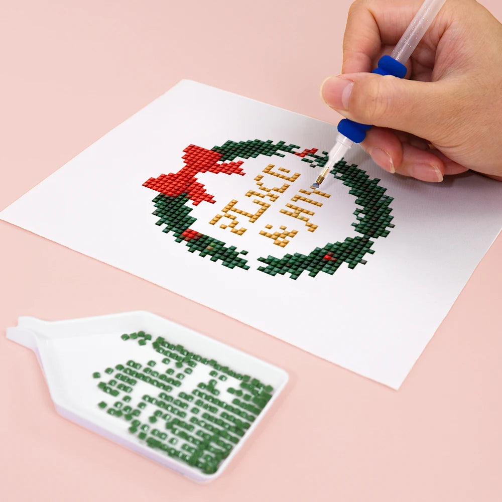 Close-up of drills being placed on a Christmas Pets & Cheer mini diamond painting design