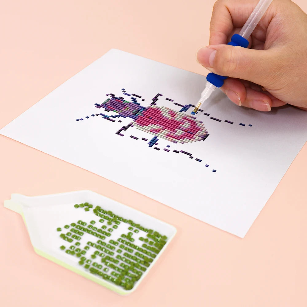 Close-up of drills being placed on a Colourful Beetles mini diamond painting design