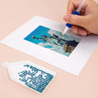 Close-up of drills being placed on a Colourful Travel Postcards mini diamond painting design