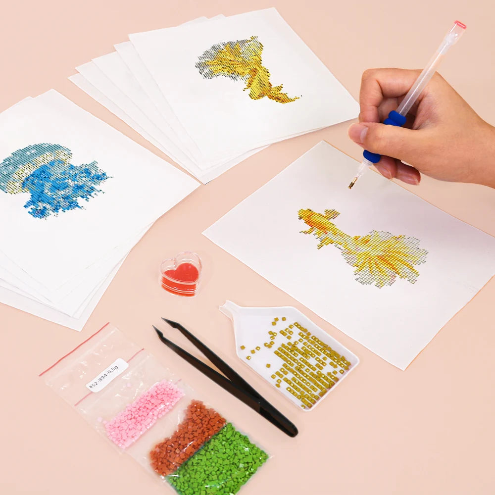 Working on several Colourful Tropical Fish mini diamond painting designs with drills and applicator