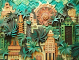 Geometric cityscape surrounded by large tropical foliage in teal, green, turquoise tones