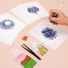 Working on several Enchanted Blue Fantasy mini diamond painting designs with drills and applicator