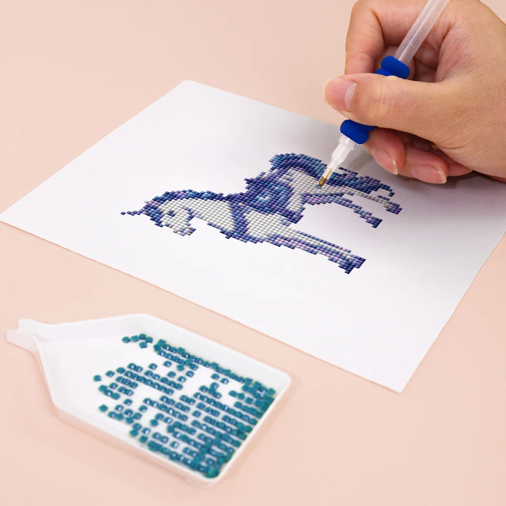 Close-up of drills being placed on a Enchanted Blue Fantasy mini diamond painting design