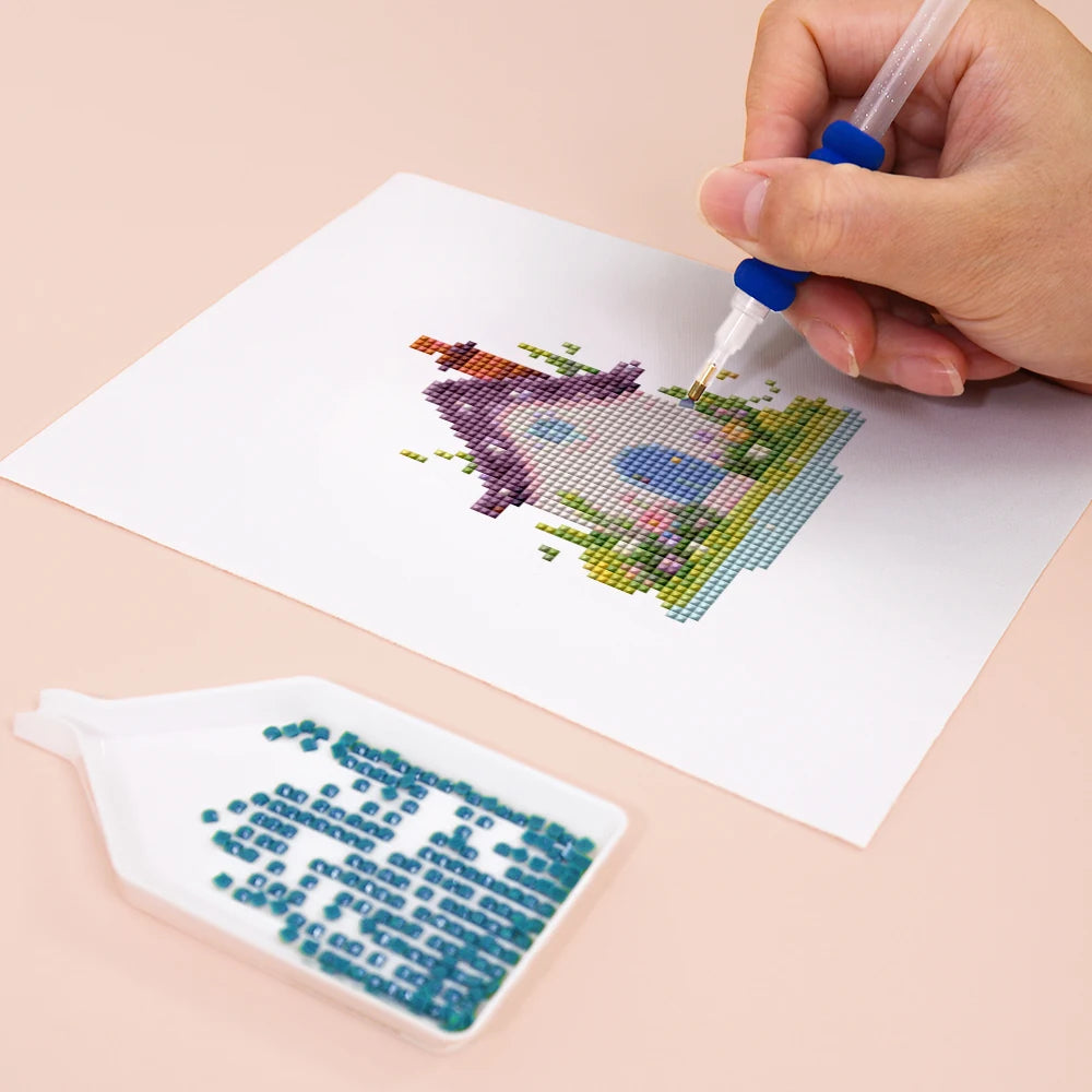 Close-up of drills being placed on a Fairy Garden Cottages mini diamond painting design