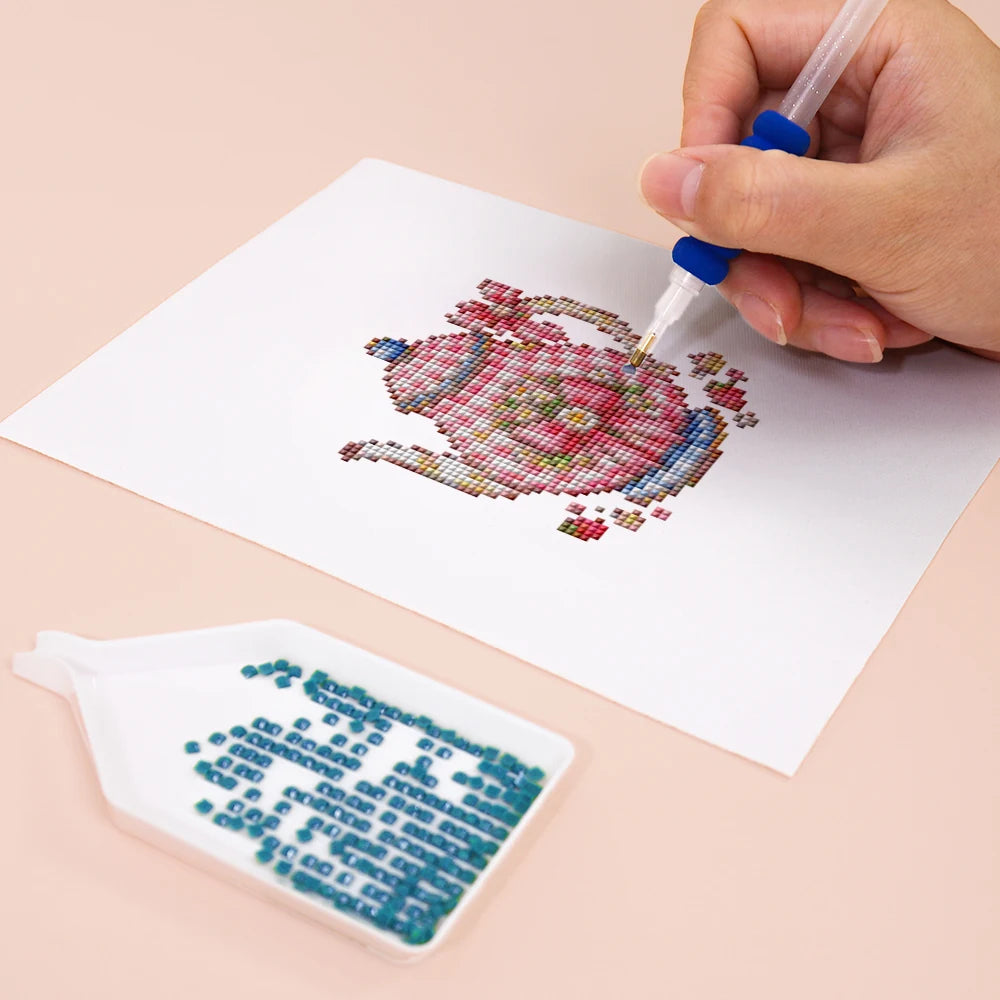 Close-up of drills being placed on a Festive Ornaments & Gifts mini diamond painting design