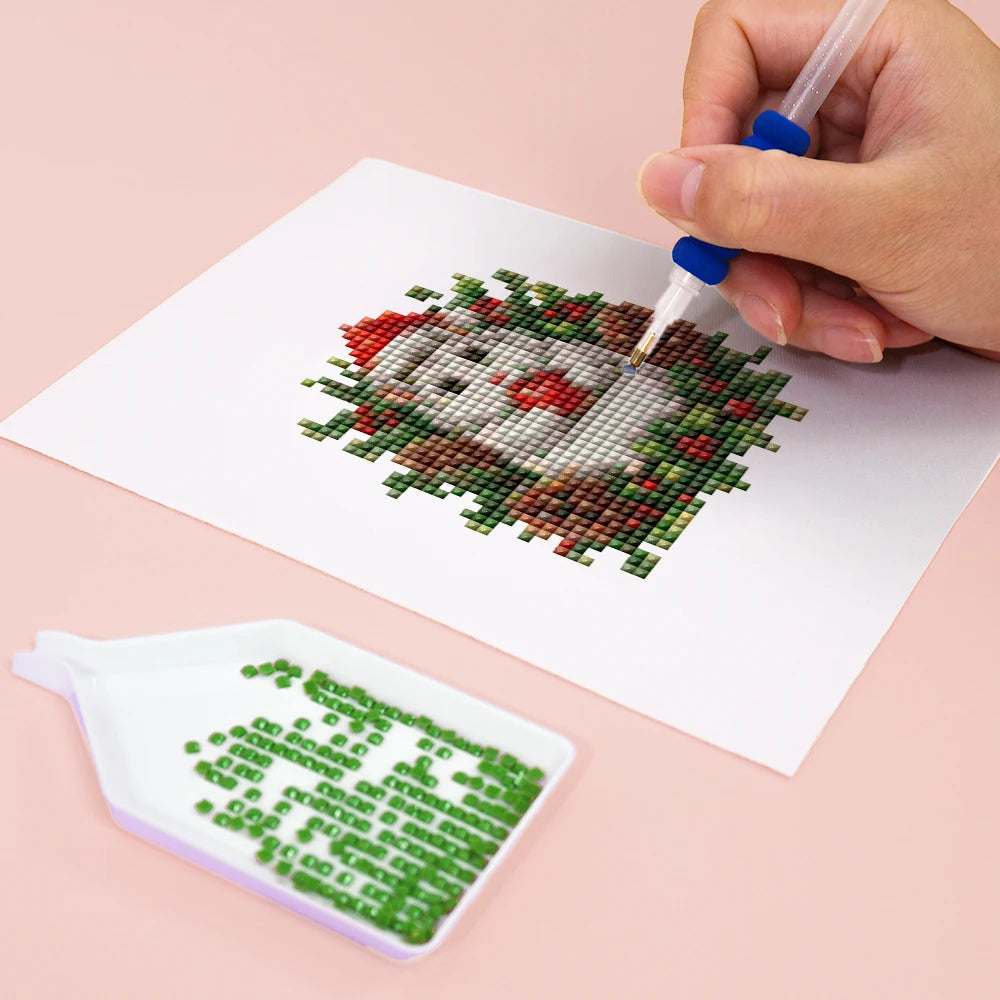 Close-up of drills being placed on a Festive Woodland Friends mini diamond painting design