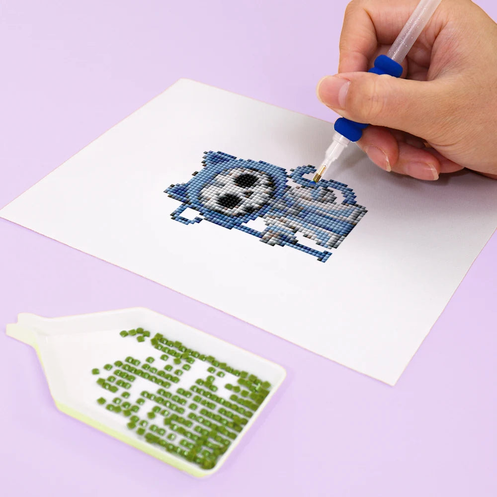 Close-up of drills being placed on a Halloween Monster Friends mini diamond painting design