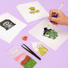 Working on several Kawaii Halloween Creatures mini diamond painting designs with drills and applicator