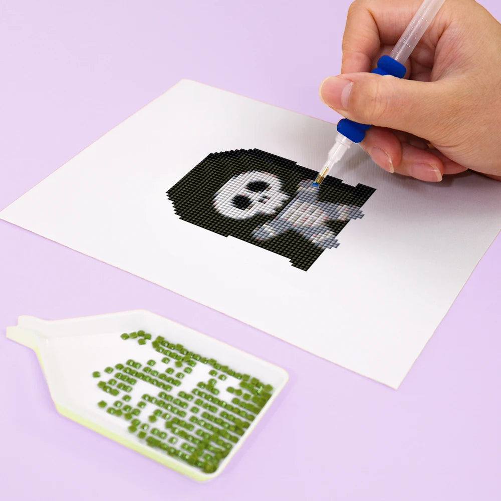 Close-up of drills being placed on a Kawaii Halloween Creatures mini diamond painting design