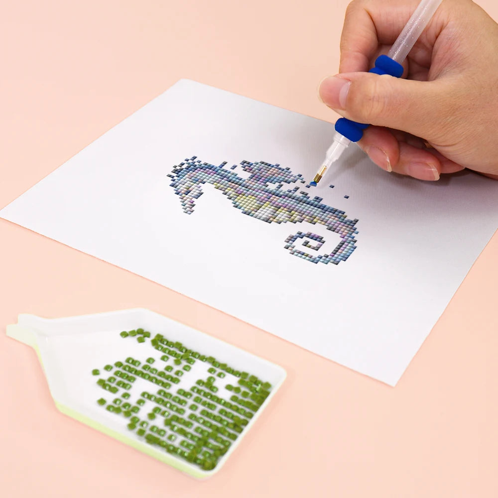 Close-up of drills being placed on a Ocean Coral & Shells mini diamond painting design