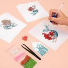 Working on several Pastel Mermaids mini diamond painting designs with drills and applicator