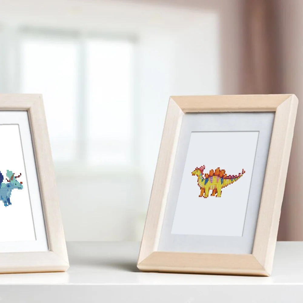 Framed Playful Dinosaurs mini diamond painting artwork displayed in a styled setting