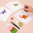 Working on several Playful Dinosaurs mini diamond painting designs with drills and applicator