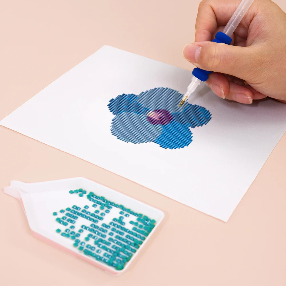 Close-up of drills being placed on a Tropical Blooms & Shells mini diamond painting design
