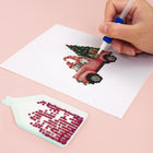 Close-up of drills being placed on a Vintage Christmas Village mini diamond painting design