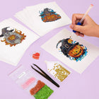 Working on several Witchy Pumpkin Parade mini diamond painting designs with drills and applicator